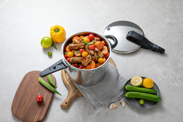 The scene of using a pressure cooker to make soup and cook dishes in the kitchen, marble countertop background, wood grain desktop