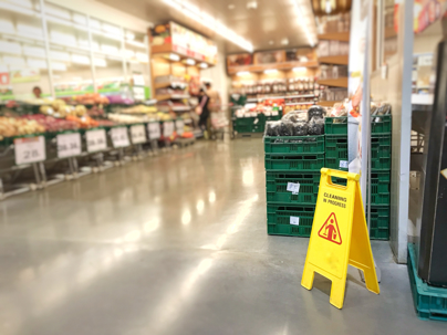 Warning signs for cleaning in grocery store