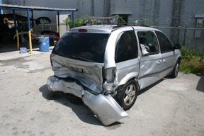 Damaged car with fallen bumper